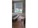 A well-lit bedroom with shuttered windows shows neutral carpet and a view of the front yard at 4232 Parliament Way, Avon, IN 46123