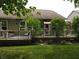 This backyard features a well-kept lawn and a raised deck with plantings at 4232 Parliament Way, Avon, IN 46123