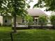 This backyard features a well-kept lawn and a raised deck with plantings at 4232 Parliament Way, Avon, IN 46123