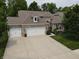 Charming single-Gathering home boasts a three-car garage, manicured lawn, and traditional brick facade at 4232 Parliament Way, Avon, IN 46123