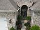 Arched entryway welcomes you with lush ferns and plantings to the brick home's front door at 4232 Parliament Way, Avon, IN 46123