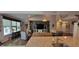 Open concept living space with a large window and a kitchen island with granite countertops at 4232 Parliament Way, Avon, IN 46123