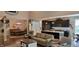 Open-concept living room with kitchen, dining area, and staircase, with warm lighting at 4232 Parliament Way, Avon, IN 46123