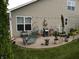 A perfect patio for relaxation, complete with grill, furniture, and garden decor at 4232 Parliament Way, Avon, IN 46123