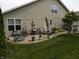 A perfect patio for relaxation, complete with grill, furniture, and garden decor at 4232 Parliament Way, Avon, IN 46123
