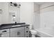 Bathroom featuring modern vanity, granite countertop, and shower-tub combination at 449 Shade St, Carmel, IN 46290