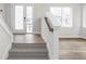 Bright entryway features carpeted stairs, wood flooring, and natural light at 449 Shade St, Carmel, IN 46290