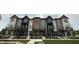New townhouses showcase modern architecture, complete with brick accents and individual balcony spaces at 449 Shade St, Carmel, IN 46290