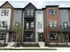 Exterior angle of new townhouses with gray siding, black brick, and individual balconies at 449 Shade St, Carmel, IN 46290