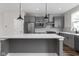 Modern kitchen featuring gray cabinets, stainless steel appliances, and a large island at 449 Shade St, Carmel, IN 46290