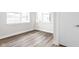 A bright, empty room with light walls, wood floors, and multiple windows at 449 Shade St, Carmel, IN 46290