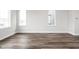 Bright living room features wood flooring and large windows offering plenty of natural light at 449 Shade St, Carmel, IN 46290