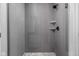 Modern shower with gray tiled walls, multiple shower heads, and built-in shelves at 449 Shade St, Carmel, IN 46290