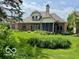 The backyard features a well-maintained lawn, brick exterior, and screened in patio at 458 Burlington Ln, Carmel, IN 46032