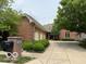 Brick home exterior with a three-car garage, mature landscaping, and a well-maintained driveway at 458 Burlington Ln, Carmel, IN 46032