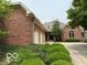Beautiful brick home with a three-car garage and well-maintained landscaping in a suburban setting at 458 Burlington Ln, Carmel, IN 46032