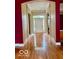 Hallway entrance leading to the living room featuring hardwood floors and arched doorway at 458 Burlington Ln, Carmel, IN 46032