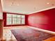 Spacious living room featuring large windows and a patterned area rug on hardwood floors at 458 Burlington Ln, Carmel, IN 46032