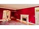 Living room featuring a fireplace, large windows, hardwood floors and an open doorway to adjacent spaces at 458 Burlington Ln, Carmel, IN 46032