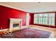 Bright living room with fireplace and multiple windows, featuring hardwood floors and a patterned rug at 458 Burlington Ln, Carmel, IN 46032