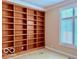 Home office with large built-in bookshelves and natural light at 458 Burlington Ln, Carmel, IN 46032