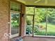 The patio offers a view of the backyard with greenery and access to screened in porch at 458 Burlington Ln, Carmel, IN 46032