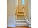Carpeted staircase with wood and white painted railings at 458 Burlington Ln, Carmel, IN 46032
