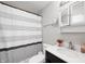 Updated bathroom with a modern vanity and stylish shower curtain at 4747 Wellington Ave, Lawrence, IN 46226