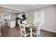 Bright dining room featuring a round table, with hardwood floors, open to kitchen, and natural light at 4747 Wellington Ave, Lawrence, IN 46226