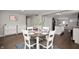 Bright dining room featuring a round table, with hardwood floors, open to kitchen, and natural light at 4747 Wellington Ave, Lawrence, IN 46226
