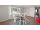 Bright dining room featuring a round table with seating for four, with hardwood floors, and natural light at 4747 Wellington Ave, Lawrence, IN 46226