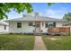Charming one-story home featuring a landscaped yard, a cozy front porch, and inviting curb appeal at 4747 Wellington Ave, Lawrence, IN 46226