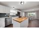 Bright eat-in kitchen with white cabinets, stainless appliances, and a butcher block island at 4747 Wellington Ave, Lawrence, IN 46226