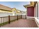 Back deck with dark brown wood, white fence, and a view of other houses, perfect for outdoor relaxation at 478 Firefly Ln, Carmel, IN 46032