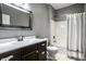 Well-lit bathroom featuring a vanity with dark wood cabinets, a framed mirror, and a shower with a white curtain at 478 Firefly Ln, Carmel, IN 46032