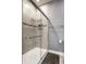 A glass door encloses the tile shower with convenient shelving at 478 Firefly Ln, Carmel, IN 46032