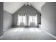 Spacious bedroom with neutral gray walls, large windows with white curtains, and soft carpet for comfort at 478 Firefly Ln, Carmel, IN 46032