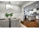 Open-concept dining area featuring hardwood floors and a view into the modern kitchen at 478 Firefly Ln, Carmel, IN 46032