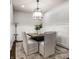 Elegant dining room with a contemporary chandelier, modern decor, and seating for six at 478 Firefly Ln, Carmel, IN 46032