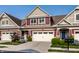 Inviting townhome featuring a two-car garage, stylish front door, and well-kept landscaping at 478 Firefly Ln, Carmel, IN 46032