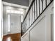 Bright foyer featuring hardwood floors, a staircase with wrought iron railing, and natural light at 478 Firefly Ln, Carmel, IN 46032