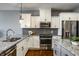 Bright kitchen showcasing granite countertops, stainless steel appliances, and stylish gray accents at 478 Firefly Ln, Carmel, IN 46032