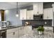Modern kitchen featuring granite countertops, stainless steel appliances, and gray subway tile backsplash at 478 Firefly Ln, Carmel, IN 46032