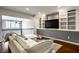 The living room features custom built-in shelving and a large television at 478 Firefly Ln, Carmel, IN 46032