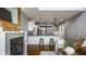 Open floor plan featuring a kitchen, bar stools, and a living room with a fireplace and hardwood floors at 478 Firefly Ln, Carmel, IN 46032