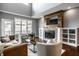 Cozy living room with a fireplace, hardwood floors, and comfortable seating arrangements at 478 Firefly Ln, Carmel, IN 46032