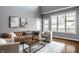 Inviting living room featuring hardwood floors, a comfortable leather sofa, and natural light at 478 Firefly Ln, Carmel, IN 46032