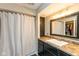 Neutral bathroom with shower/tub combo, featuring dark cabinets, granite countertop, and a large mirror at 4965 Hawthorne Way, Avon, IN 46123