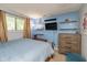Cozy bedroom features blue accent wall, natural light, and shelving for storage at 4965 Hawthorne Way, Avon, IN 46123