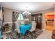 Elegant dining area with a chandelier, a bold blue tablecloth, and decorative curtains, next to wooden china cabinet at 4965 Hawthorne Way, Avon, IN 46123